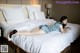 A woman laying on a bed in a hotel room.