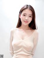 A woman in a white sweater posing for a picture.